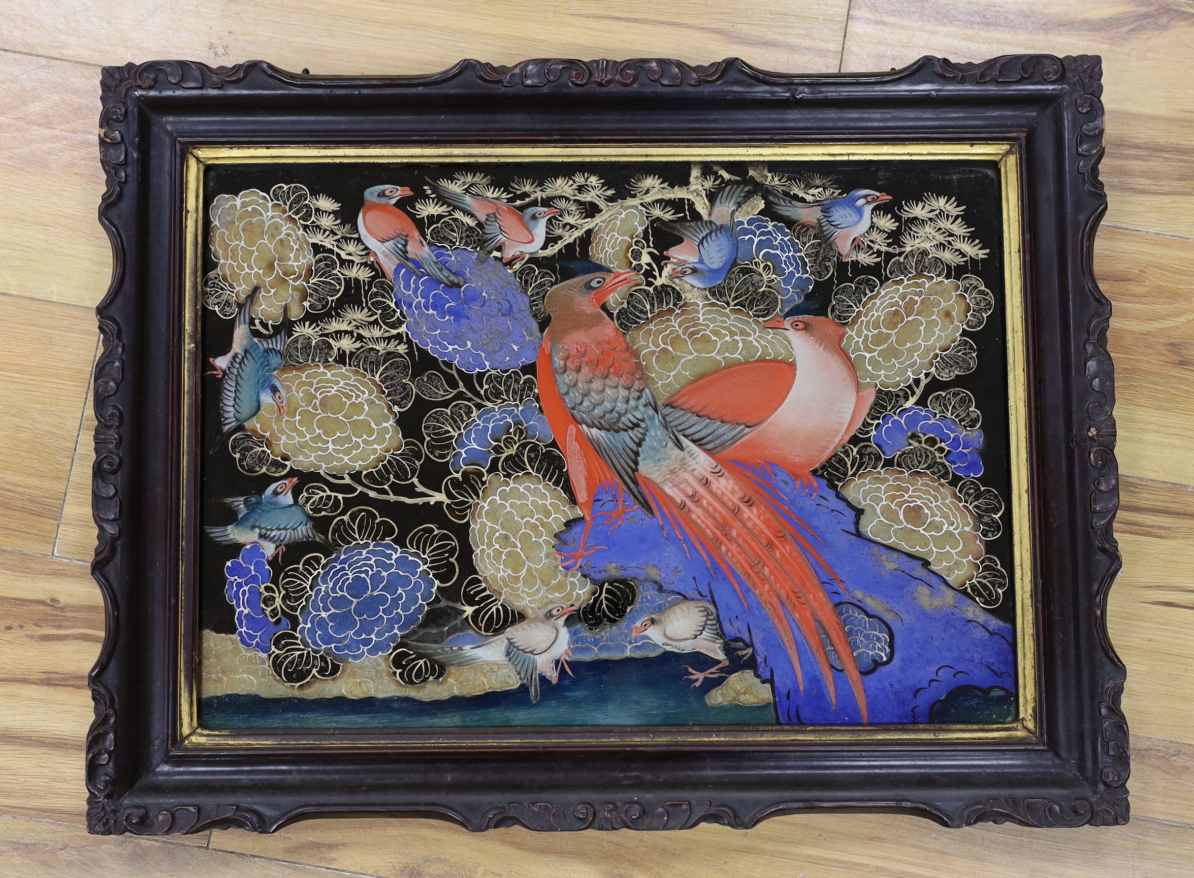 A framed Korean glass painted panel of birds of paradise, 62cm x 47cm